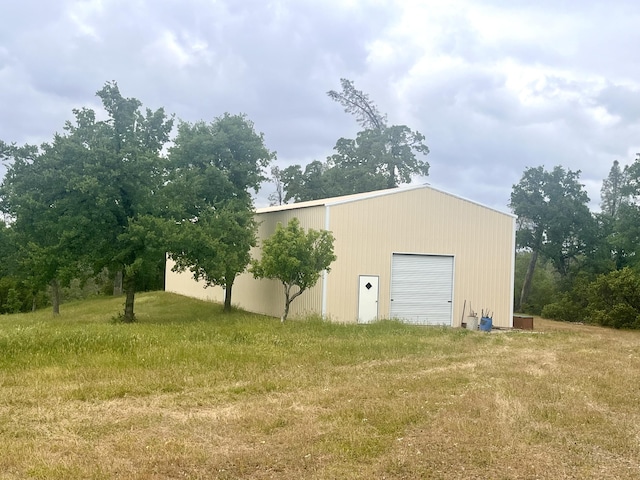 view of pole building with a lawn
