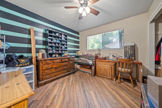 office space with a ceiling fan and light wood-type flooring