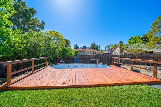 deck with a fenced backyard and a yard