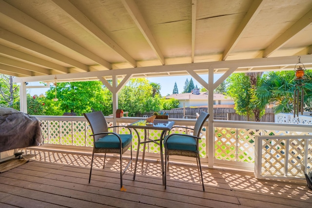 wooden deck with grilling area and fence