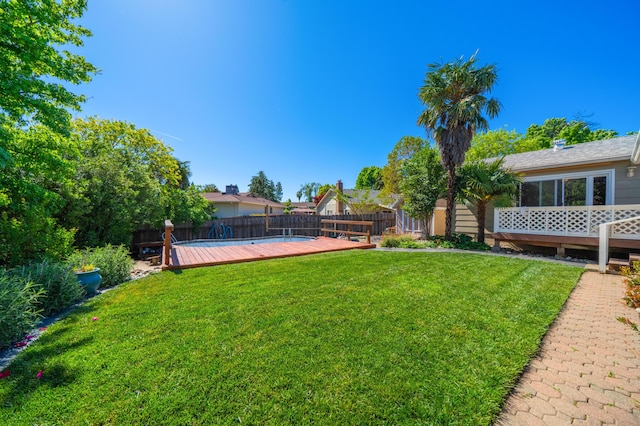view of yard with a fenced backyard and a wooden deck
