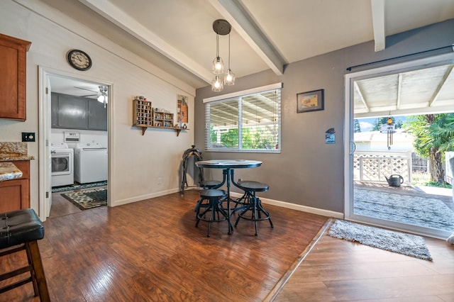 dining area featuring baseboards, washer and clothes dryer, and dark wood-type flooring