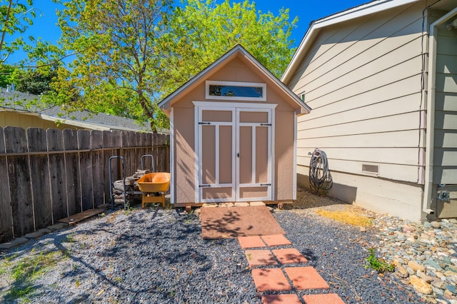 view of shed with fence