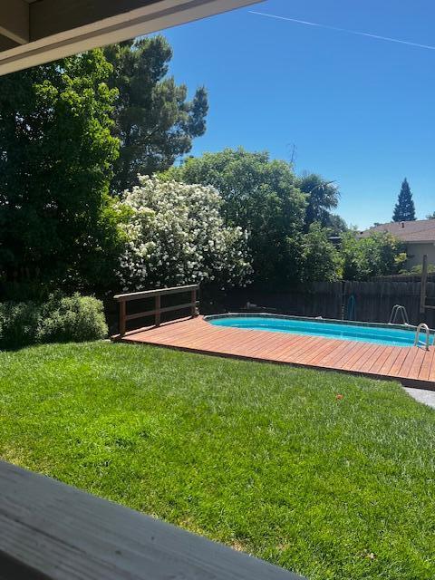 4065 Meander Dr, Redding, CA 96001 - view of pool with a wooden deck and a fenced backyard