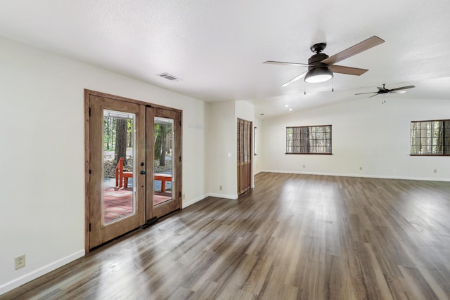 unfurnished living room featuring french doors, ceiling fan, wood finished floors, baseboards, and vaulted ceiling