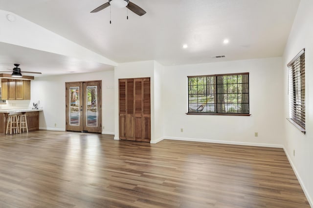 unfurnished living room with a ceiling fan, baseboards, recessed lighting, and vaulted ceiling