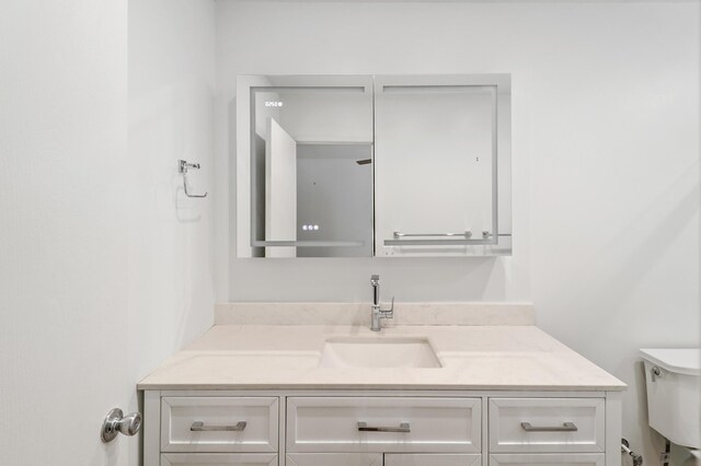 bathroom with vanity and toilet