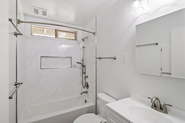 bathroom featuring toilet, vanity, and bathing tub / shower combination