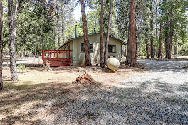 view of property exterior with a wooden deck