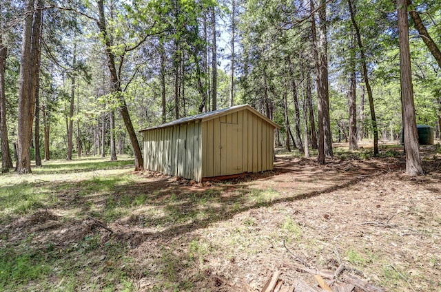 view of shed featuring a wooded view