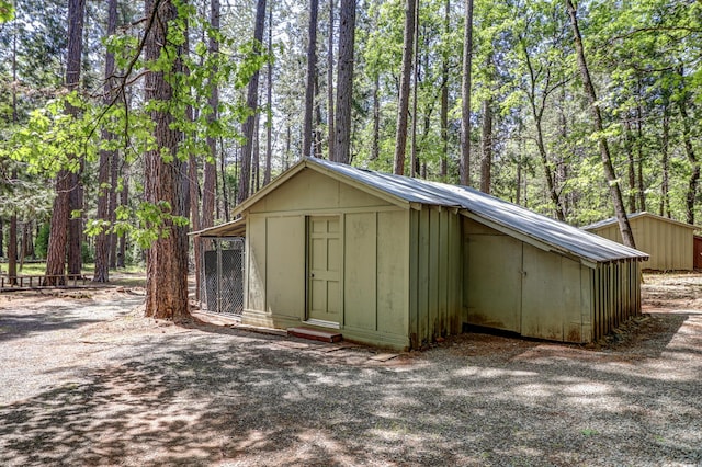 view of shed featuring a forest view