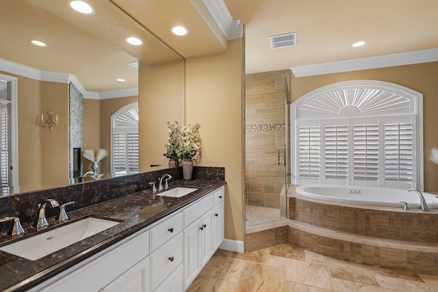 full bathroom with a sink, ornamental molding, a shower stall, and visible vents