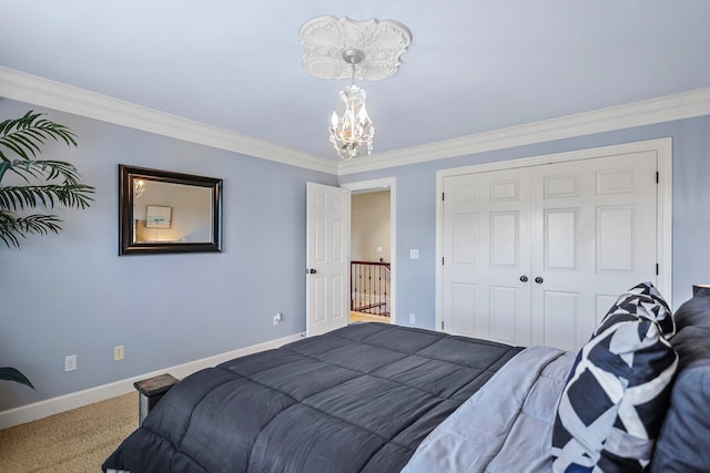 bedroom featuring crown molding, a closet, baseboards, carpet, and a notable chandelier