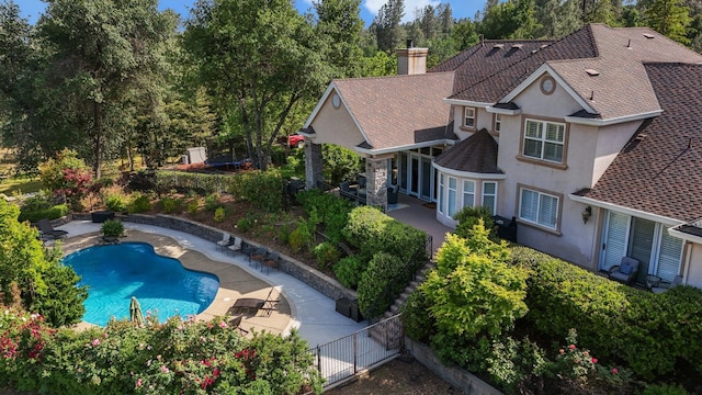 view of pool featuring fence, a fenced in pool, and a patio area