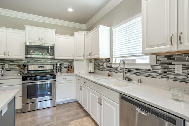 20295 Ballentine Dr, Anderson, CA 96007 - kitchen with a sink, appliances with stainless steel finishes, ornamental molding, and white cabinets