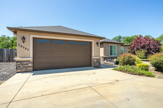 20295 Ballentine Dr, Anderson, CA 96007 - prairie-style house with fence, concrete driveway, an attached garage, stone siding, and stucco siding