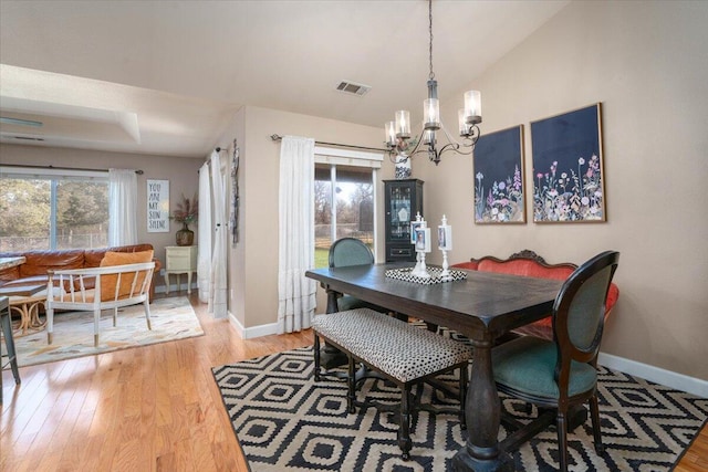dining area with a notable chandelier, baseboards, and a healthy amount of sunlight