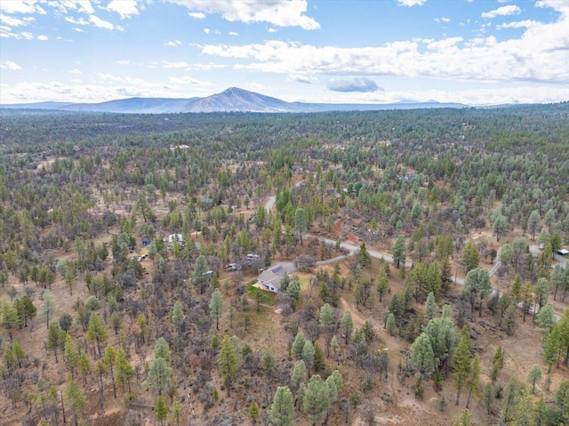 aerial view with a wooded view and a mountain view