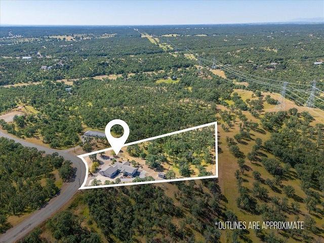 drone / aerial view featuring a forest view