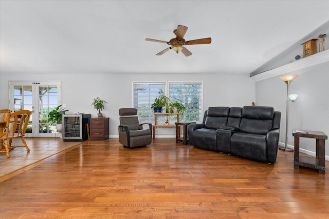 living area with a ceiling fan and wood finished floors