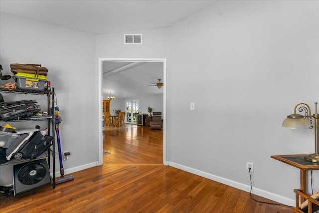 interior space featuring baseboards, visible vents, and wood finished floors