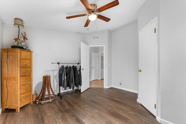 bedroom with ceiling fan, baseboards, visible vents, and wood finished floors