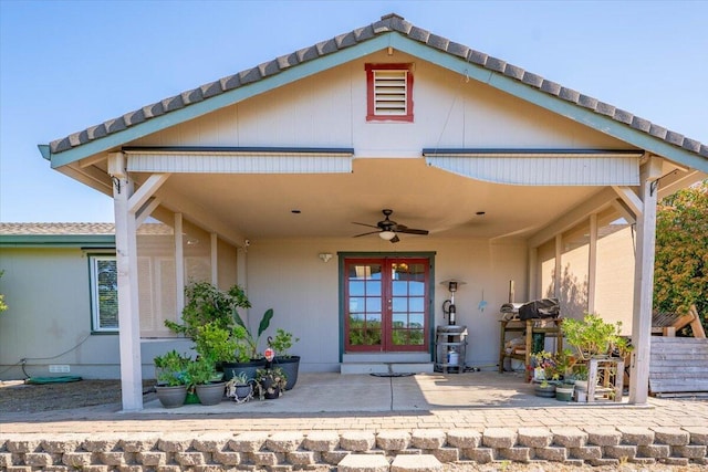 exterior space featuring french doors, a tiled roof, and a ceiling fan