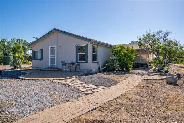 rear view of house featuring a patio