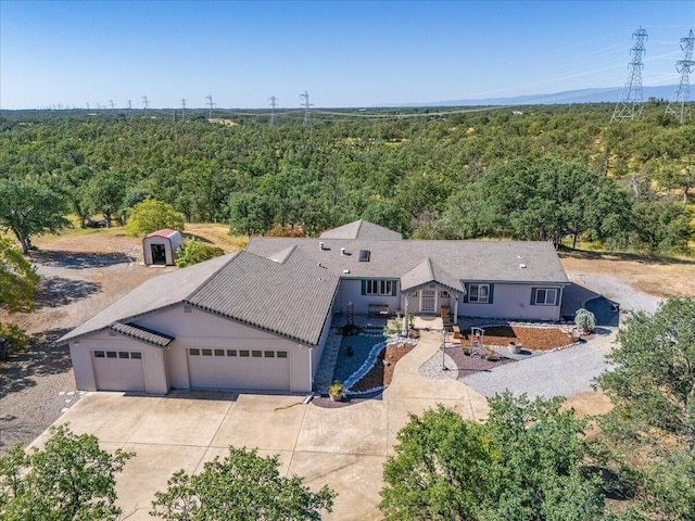 birds eye view of property with a forest view