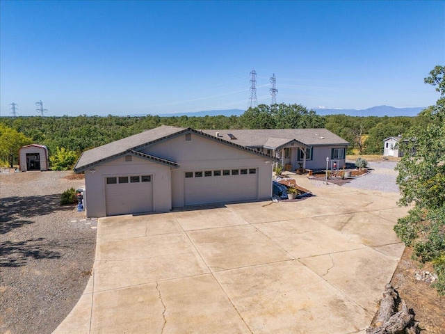 single story home featuring a garage and driveway