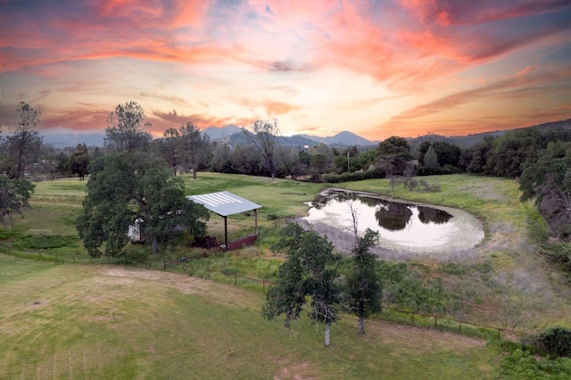 aerial view at dusk with a water and mountain view