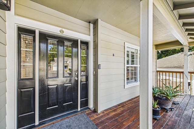view of exterior entry featuring a porch
