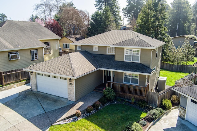 traditional-style house with driveway, a front yard, fence, a porch, and a garage