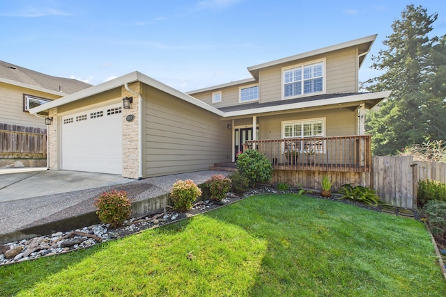 traditional home featuring fence, a front lawn, driveway, and an attached garage