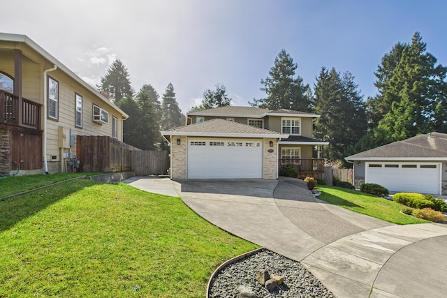 traditional home with a front lawn, driveway, a garage, and fence