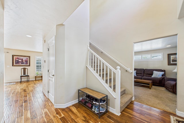 stairway with visible vents, hardwood / wood-style floors, recessed lighting, and baseboards