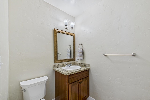 bathroom featuring toilet and vanity