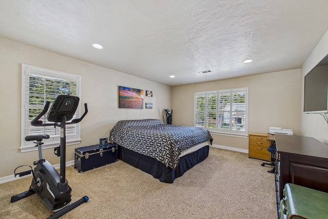 carpeted bedroom featuring recessed lighting, visible vents, and baseboards