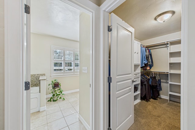 spacious closet with light tile patterned flooring