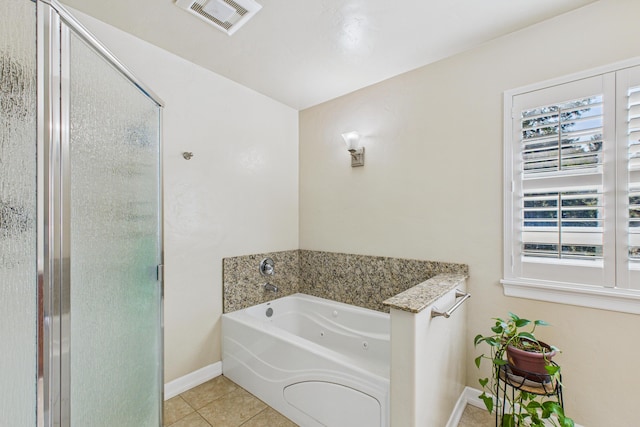 full bathroom featuring tile patterned floors, a stall shower, visible vents, baseboards, and a tub with jets