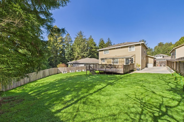 back of house with a patio, a deck, a yard, and a fenced backyard
