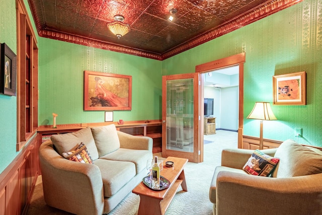 sitting room with an ornate ceiling and carpet floors