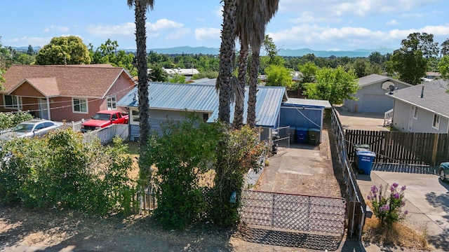 3169 Veda St, Redding, CA 96001 - view of home's exterior featuring metal roof, a mountain view, a residential view, and concrete driveway