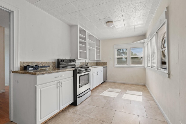 3169 Veda St, Redding, CA 96001 - kitchen featuring appliances with stainless steel finishes, open shelves, white cabinetry, a sink, and baseboards