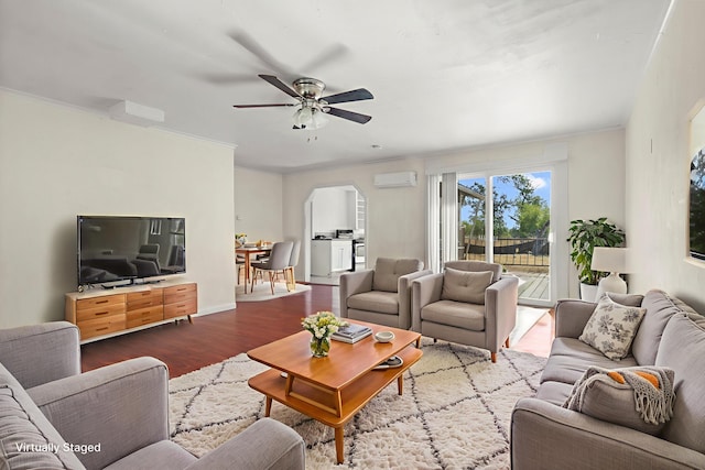 3169 Veda St, Redding, CA 96001 - living room with a wall mounted air conditioner, dark wood-style floors, arched walkways, ceiling fan, and ornamental molding
