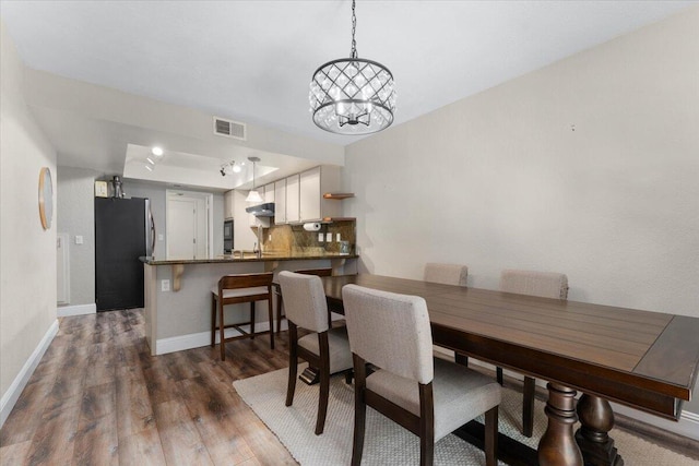 1968 Bechelli Ln, Redding, CA 96002 - dining space featuring dark wood-style floors, baseboards, and a chandelier