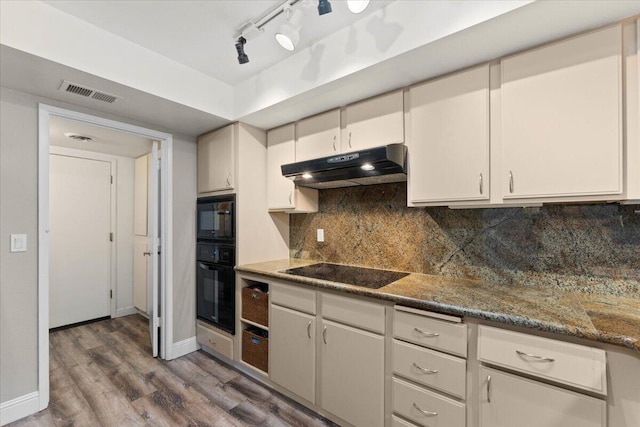 1968 Bechelli Ln, Redding, CA 96002 - kitchen featuring under cabinet range hood, black appliances, wood finished floors, and backsplash