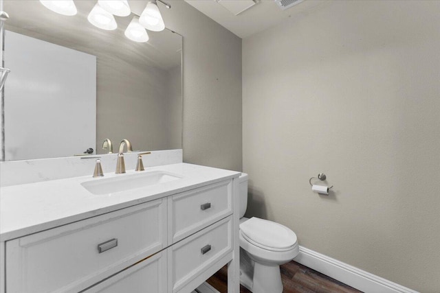 1968 Bechelli Ln, Redding, CA 96002 - bathroom with toilet, vanity, wood finished floors, and baseboards