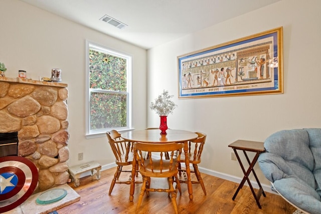 3301 Bridger Dr, Redding, CA 96002 - dining area featuring wood finished floors, baseboards, and a fireplace