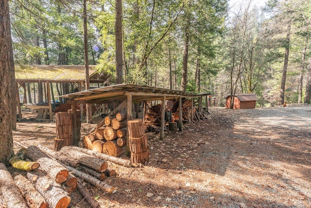 view of shed with a wooded view
